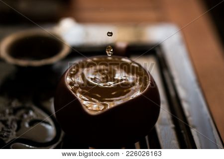 Green Tea Pouring With Drops In Traditional Chinese Tea Ceremony