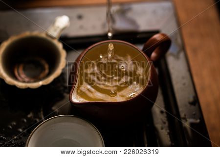 Green Tea Pouring In Traditional Chinese Tea Ceremony