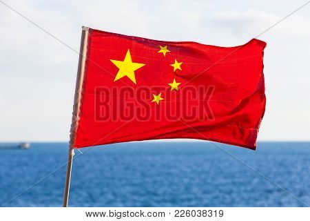 The Chinese National Flag Against Blue Sea