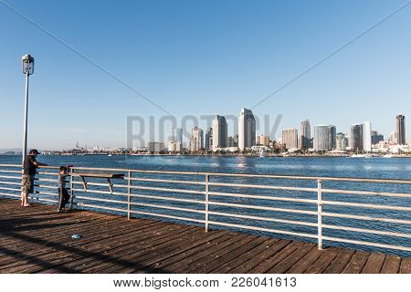 Coronado, California - February 4, 2018:  A Man And Boy Fish From The Dock Of The Coronado Ferry Lan