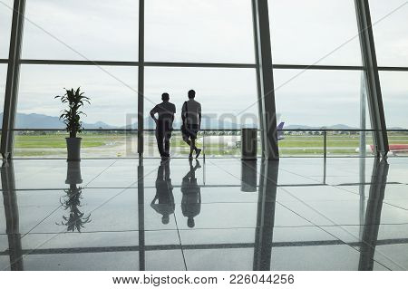 Airline Passengers Silhouettes And Reflections At Airport