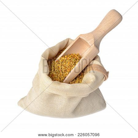 Flower Bee Pollen In A Bag Of Natural Cloth And A Wooden Slove Is Isolated On A White Background.nat