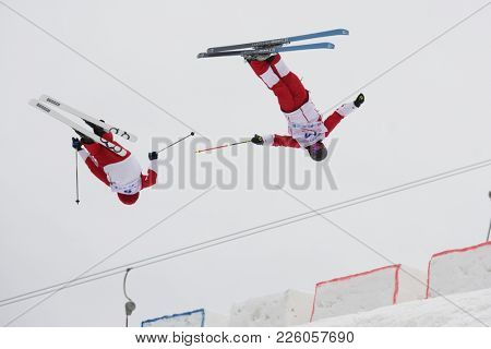 KRASNOE OZERO, LENINGRAD REGION, RUSSIA - FEBRUARY 1, 2018: Nikita Parkachev (14) and Ilya Chevskiy, both of Russia, compete in dual mogul during Freestyle Europa Cup competitions. Chevskiy won bronze