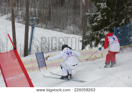 KRASNOE OZERO, LENINGRAD REGION, RUSSIA - FEBRUARY 1, 2018: Anton Axellie (37) of Sweden and Ilya Chevskiy of Russia compete in dual mogul during Freestyle Europa Cup competitions. Chevskiy won bronze