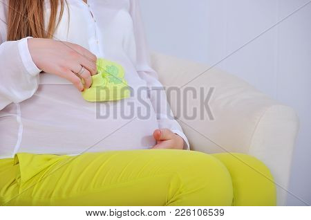 Belly Of A Pregnant Woman With Flower