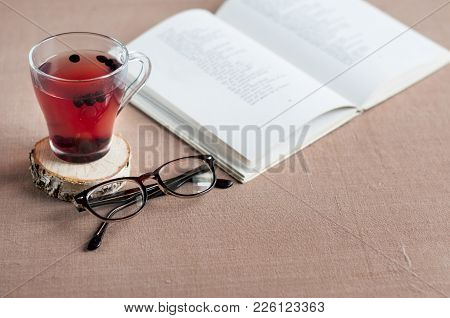 Blueberry Tea To Strengthen Vision With Empty White Paper, Eyeglasses  Against The Background Of Boo