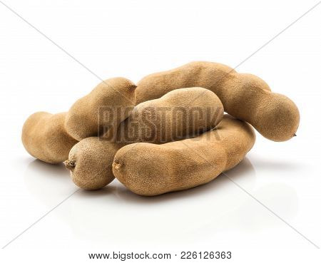 Tamarind Four Indian Dates In A Brown Brittle Shell Isolated On White Background