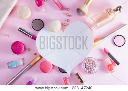 Make Up Products And Macaroons Flat Lay Layot With Copy Space On Pink Background