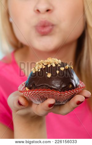 Diet, Sweets, Food Concept. Woman Holding Delicious Chocolate Cupcake With Peanut Frosting About To 