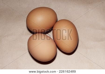 Brown Eggs On The Brown Paper Rustic Background.