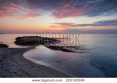 Sea Sunrise At The Black Sea Coast Near Ravda, Bulgaria. Rocky Sunrise.