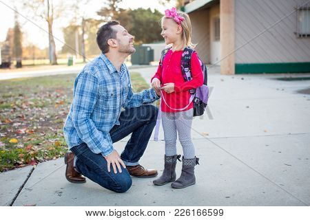 Father picking daughter up from school