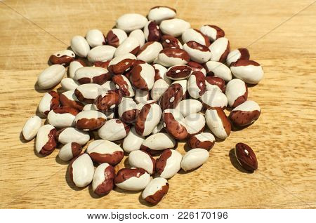 A Pile Of Painted Pony Italian Borlotti Cranberry Beans Closeup On Wooden Board