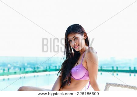 Swimsuit Concept. Beautiful Girl Wearing Pink Swimsuit. Beautiful Girl In Swimwear Is Relaxing At Th
