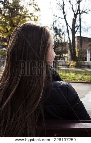 An Autumn Woman Sitting On A Banch