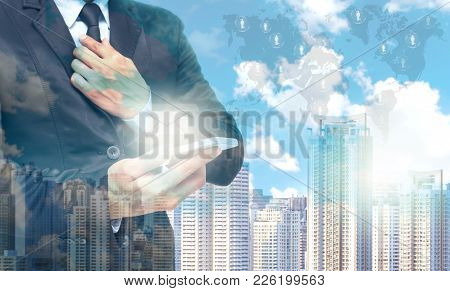 Double Exposure Of Businessman Using The Tablet For Sending The Email On World Map And Cityscape Bac