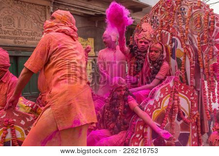 Vrindavan, India - March 19, 2016: Colourful Holi procession on the streets of Vrindavan, Uttar Pradesh, India.