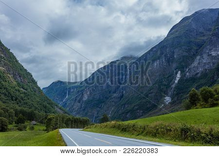 Beautiful Norway Landscape In Cloudy Day. Road, Waterfalls, Mountains