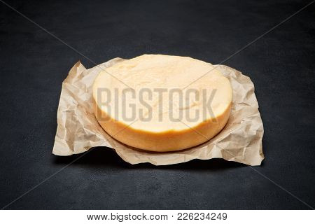 Whole Round Head Of Parmesan Or Parmigiano Hard Cheese On Concrete Background Or Table