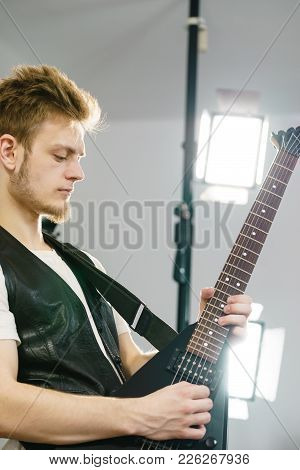 Teen Hardcore Man Wearing Metal Outfit Playing On Electric Guitar Heavy Rock Music Teen Hardcore Man Wearing Metal Outfit Playing On Electric Guitar Heavy Rock Music