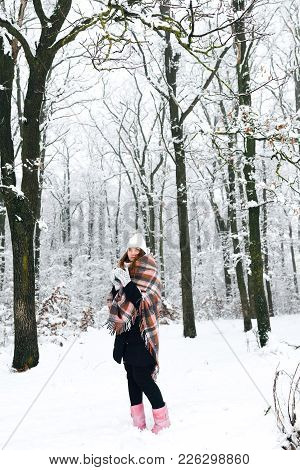 A Girl In A Plaid Drinks Tea In Winter