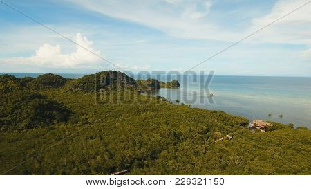 Aerial View: Sea And The Tropical Island With Rocks, Beach And Waves. Coastline Of The Tropical Isla