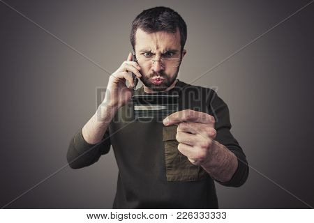 Angry Young Man Having An Argument With His Bank For The Credit Card Bill He Received