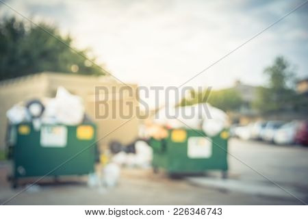 Overflowing Dumpster At Apartment Building Yard In America