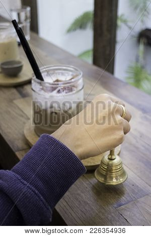 Hand On Brass Bell In Coffee Shop, Stock Photo