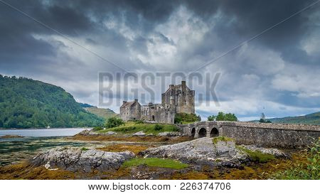 Eilean Donan Castle, Loch Duich, Scotish Highlands, United Kingdom With A Cloudy Dramatic Sky