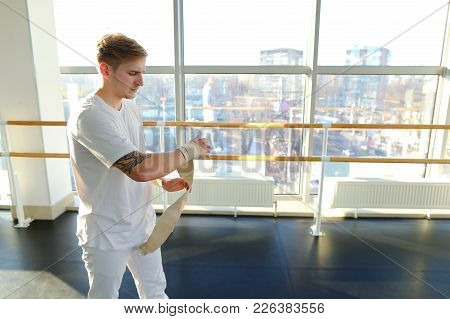 Ceo Of It-company In Sportswear Discussing Business On Smartphone During Training, Young Man Receive