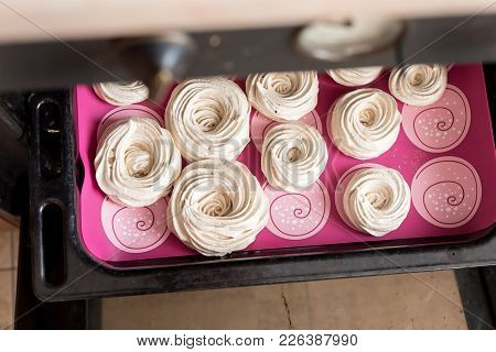 White Tasty Meringues Baking In Oven, Cooking Food