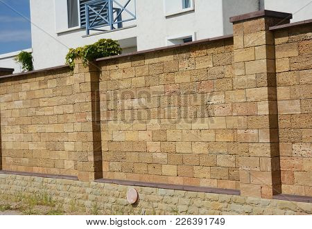 Close Up On Coquina Or Shelly Limestone Fence Wall. Natural Fencing.