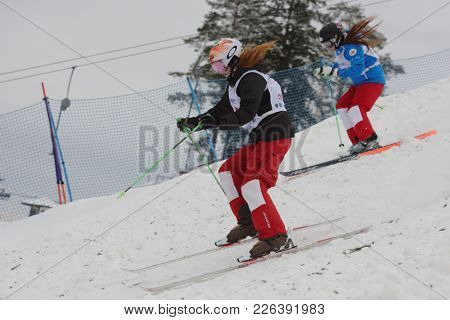 KRASNOE OZERO, LENINGRAD REGION, RUSSIA - FEBRUARY 1, 2018: Yelizaveta Bezgodova (blue) and Anastasia Kulikova, both of Russia, compete in dual mogul during Freestyle Europa Cup competitions