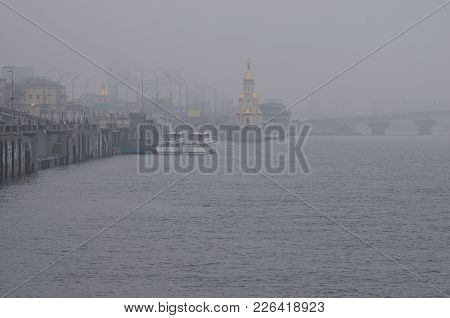 View To The Embankment Near The River Port. Foggy Cityscape. Kyiv, Ukraine. Misty Winter Morning.