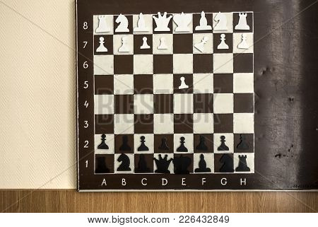 Wall Old Chessboard With Magnetic Plastic Figures Hanging On The Wall For Learning To Play Chess.