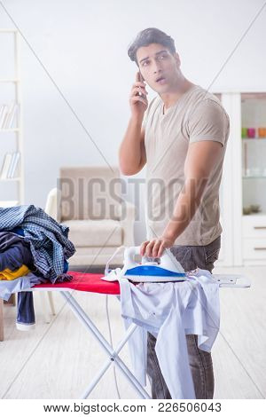 Inattentive husband burning clothing while ironing