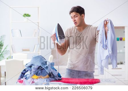 Inattentive husband burning clothing while ironing