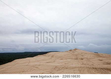 Panorama Of The Pilat Dune (dune Du Pilat) During A Cloudy Afternoon With A Pine Forest In Backgroun