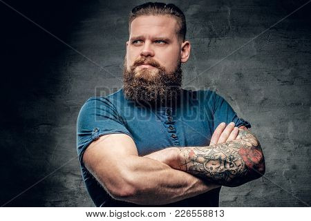 Bearded Fat Male With Tattoo On Arms Posing Over Grey Background.