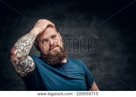 Bearded Fat Male With Tattoo On Arms Posing Over Grey Background.