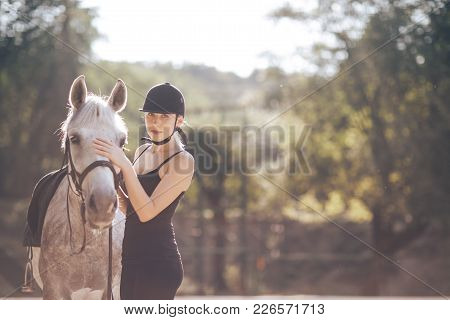 Beautiful Young Woman With A Horse Outdoor