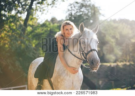 Young Blonde Girl Riding Her Horse Outdoor