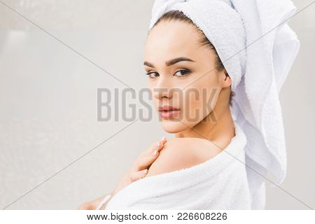 Side View Of Beautiful Young Woman In Bathrobe With Towel On Head At Home