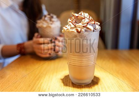 Latte Macchiato In Tall Glass Close Up. Coffee On A Table In Cafe