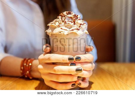 Latte Macchiato In Tall Glass Close Up. Coffee On A Table In Cafe