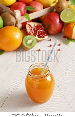 Juice And Fruits On Background. Healthy Lifestyle. A Glass Of Freshly Squeezed Juice On The Backgrou
