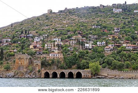 Shipyard And The Ruins Of A Medieval Fortress On The Mountainside In Alanya, Turkey