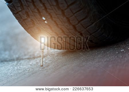 Car Tyre Stung With Nail. The Nail Stung The Black Rubber Tire Of The Old Car It Is A Part Of The Wh