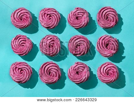 Capcake With Marshmallows On A Turquoise Paper Background